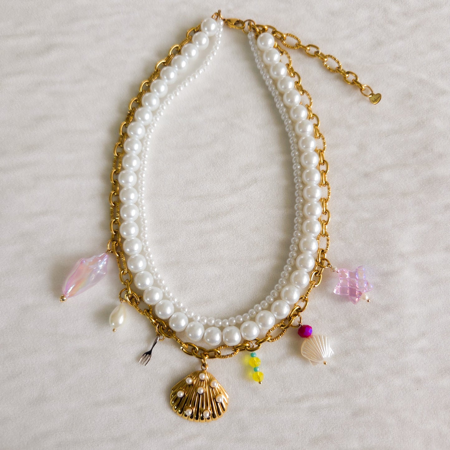 Three-layer Ariel-inspired necklace with glass pearls, gold-plated ocean-themed charms, and stainless steel chain. Handmade Disney princess jewelry.